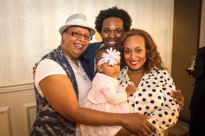 Elizabeth Rhodes, left, with her son-in-law Hashim Lafond, granddaughter Anaiah Lafond, and daughter Johnetta Lafond at Boston Medical Center’s Catwalk for Cancer Care fundraiser. Rhodes has battled breast cancer twice in her life. She credits her survival to early detection through a mammogram in 1994. 	Photo courtesy Atlantic Photo - Boston